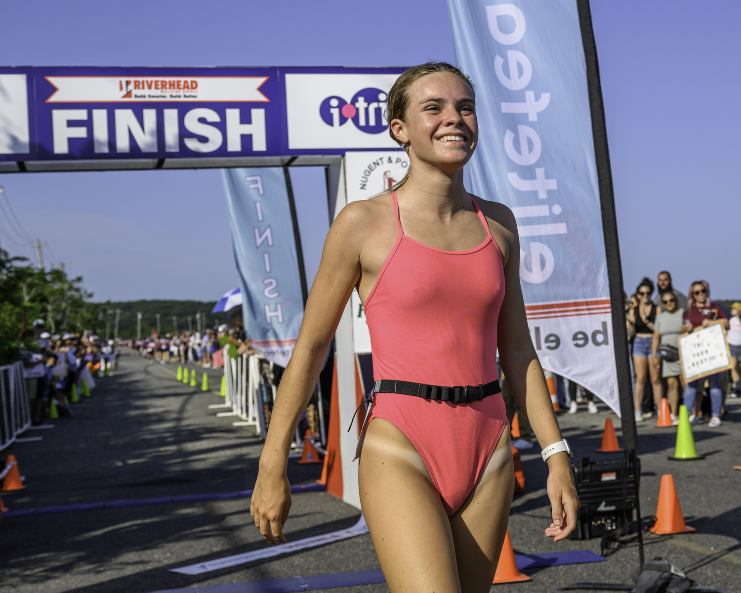 Vanessa Rizzo of Sagaponack is all smiles after finishing the Hamptons Youth Triathlon first on Sunday morning.  MARIANNE BARNETT