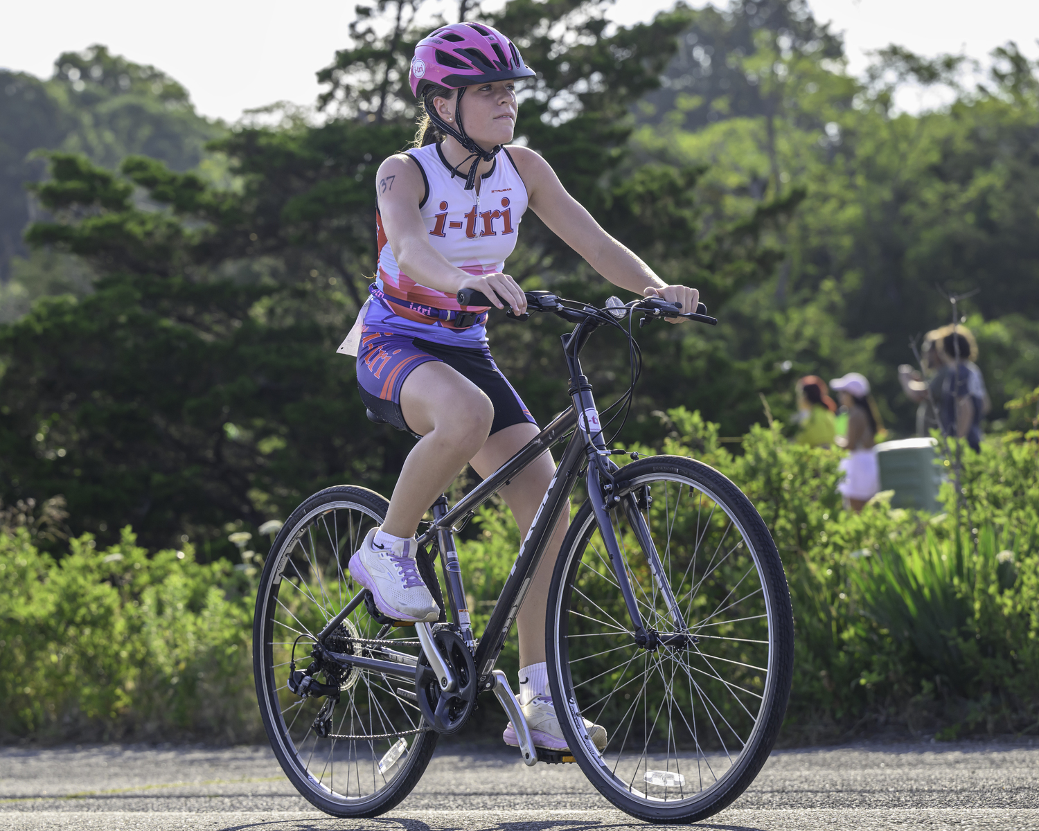 Heidi Rizzo of Sagaponack, the first i-tri finisher, in the bike portion of the triathlon.  MARIANNE BARNETT