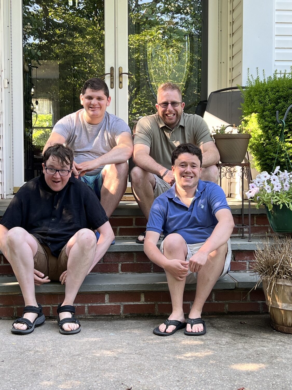 Residents at L'Arche Long Island, top row, Christopher H. and Alex B., and bottom row, Julian G. and Collier L. COURTESTY KATHLEEN COLON