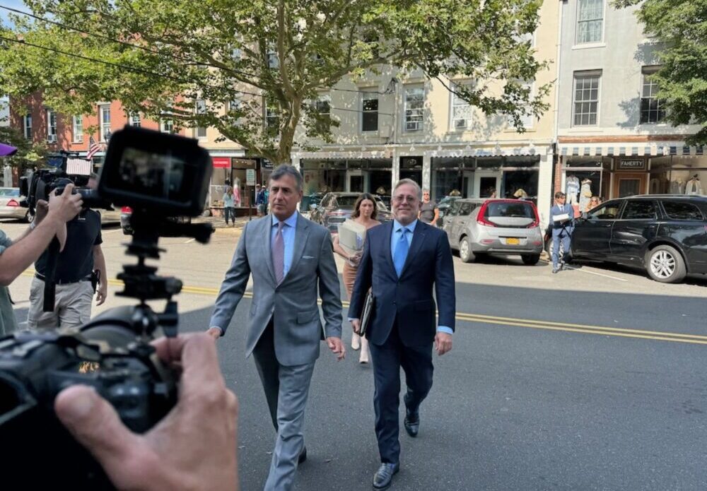 Justin Timberlake's attorney Ed Burke, in the gray suit, outside Sag Harbor Village Justice Court on Friday, July 26. T.E. McMORROW