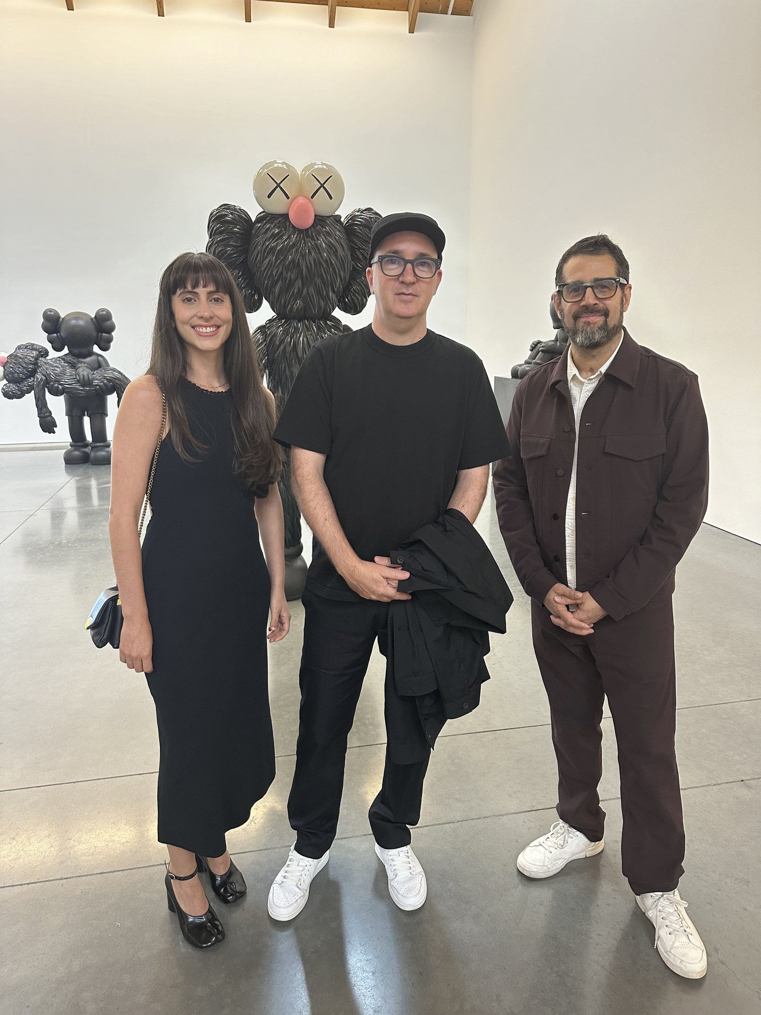 Claudia Hilda, Artist KAWS and Jose Parla at the Parrish Art Museum Dinner Party.  GREG D'ELIA