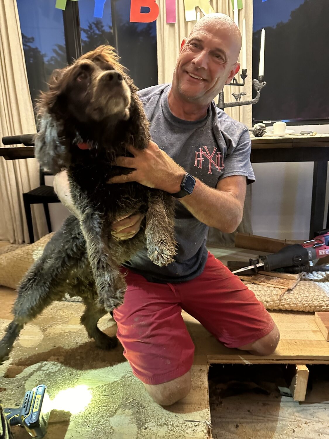 Mark Gregory of the East Quogue Fire Department rescued Alfi, a Boykin Spaniel, after she'd gotten wedged underneath the floor joists of her East Quogue home chasing a groundhog under the house.