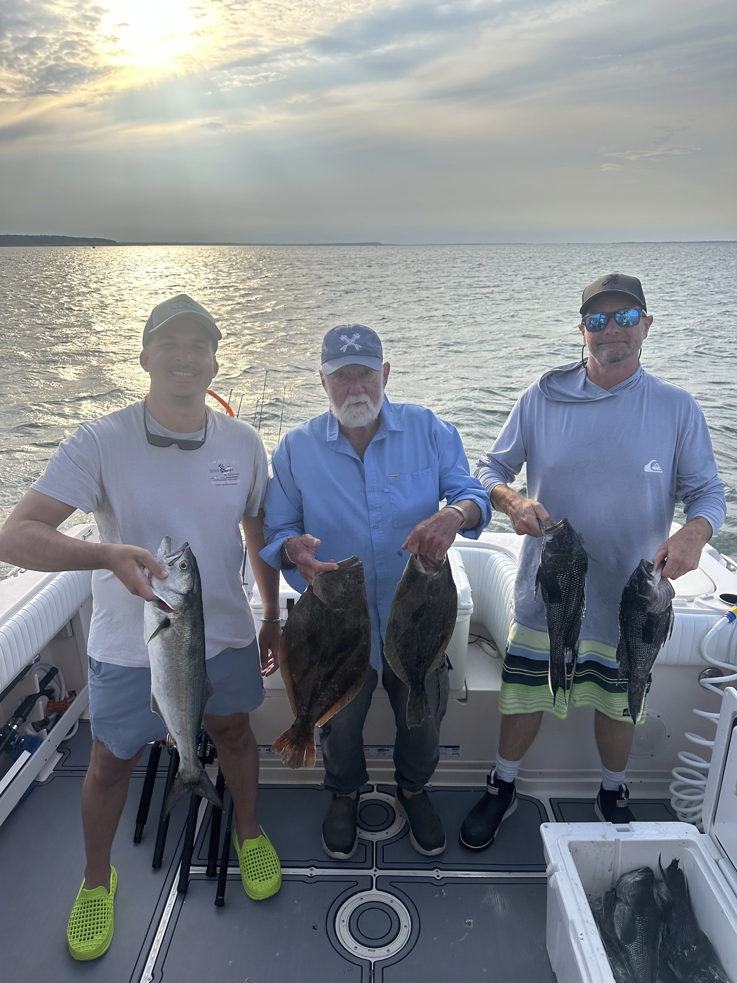 Matt Charters, Al Daniels and Mark Daniels with their catch of bluefish, fluke and seabass from their Montauk trip.   COURTESY SUE DANIELS