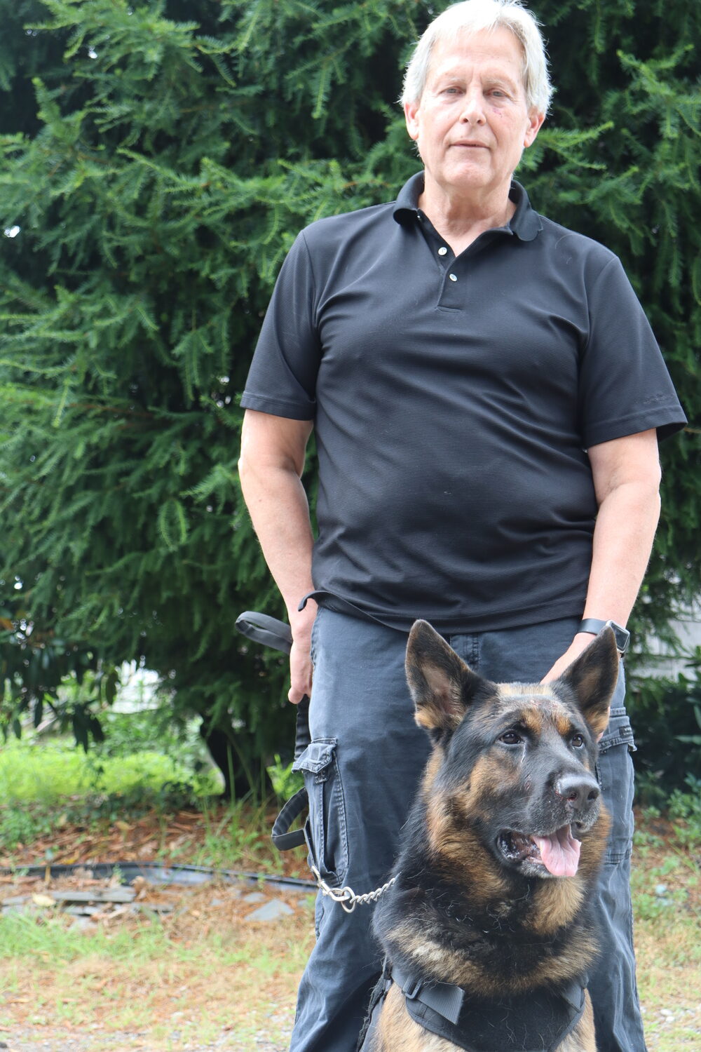 Duane Moore and Bear, one of seven German Shepherds he owns, at their Shinnecock Hills home. Dr. Will Spanbock and Dr. Tomas Infernuso performed sinus surgery on Bear for a persistent fungal infection that had plagued the dog for months. CAILIN RILEY