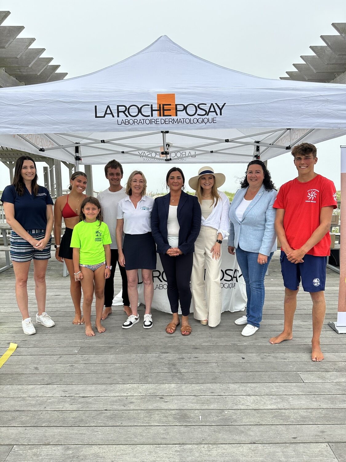 Town Councilwoman Cyndi McNamara, Parks and Recreation Director Kristen Doulos, UnionDerm employees and town lifeguards at Ponquogue Beach. DAN STARK