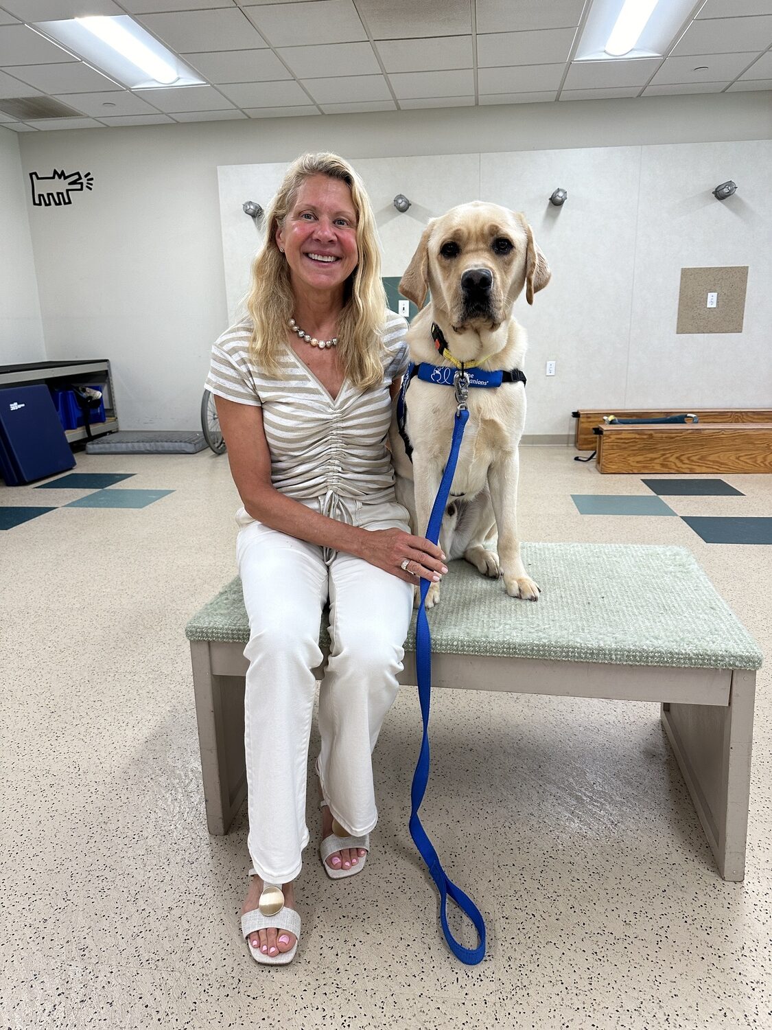 Heidi Petschauer with one of the dogs at Canine Companions' Northeast Training Center in Medford. DAN STARK