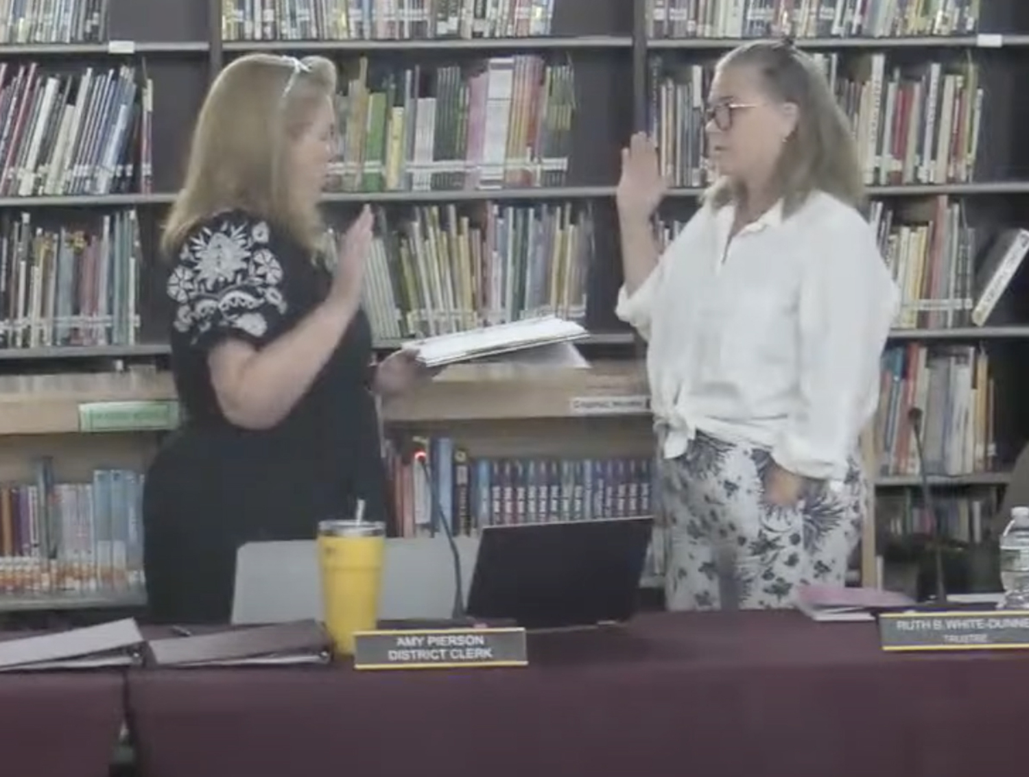 Southampton Schools District Clerk Amy Pierson swears in Jacqueline Robinson as president of the Board of Education.