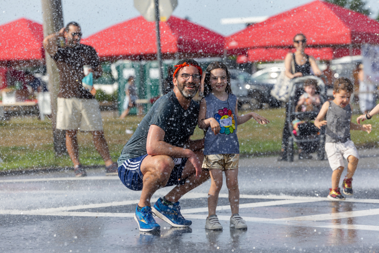 Enjoying the shower provided by the Westhampton Beach Fire Department.   RON ESPOSITO