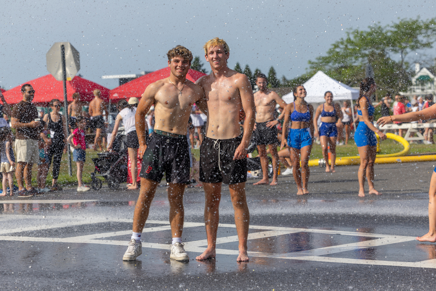 Cooling off in the shower provided by the Westhampton Beach Fire Department.   RON ESPOSITO