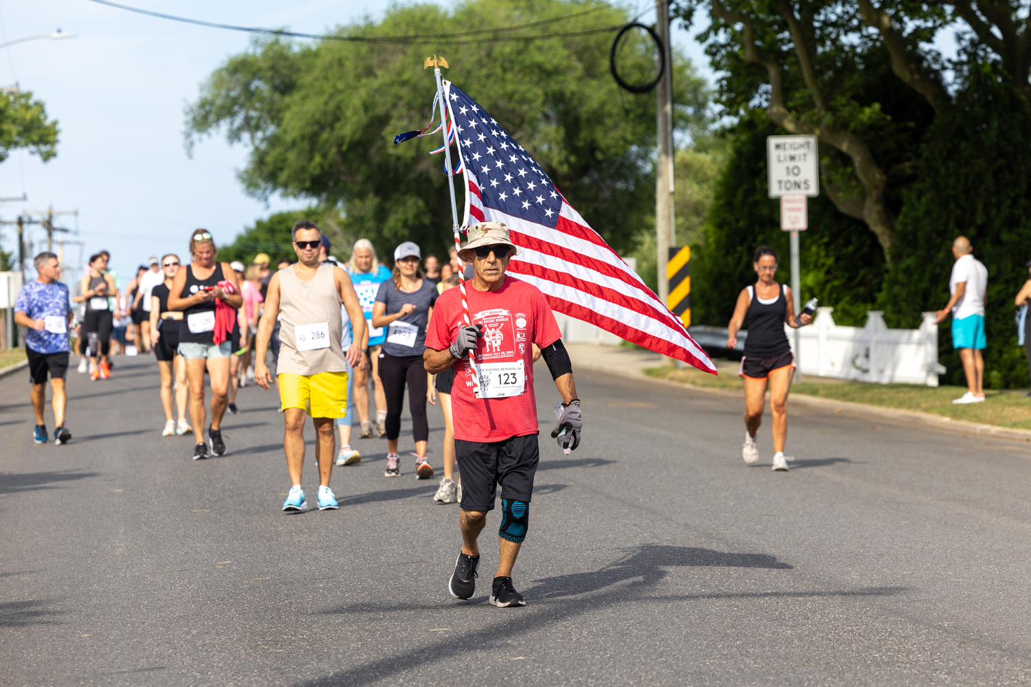 Joe Sferrazza of Manorville carries the flag.   RON ESPOSITO