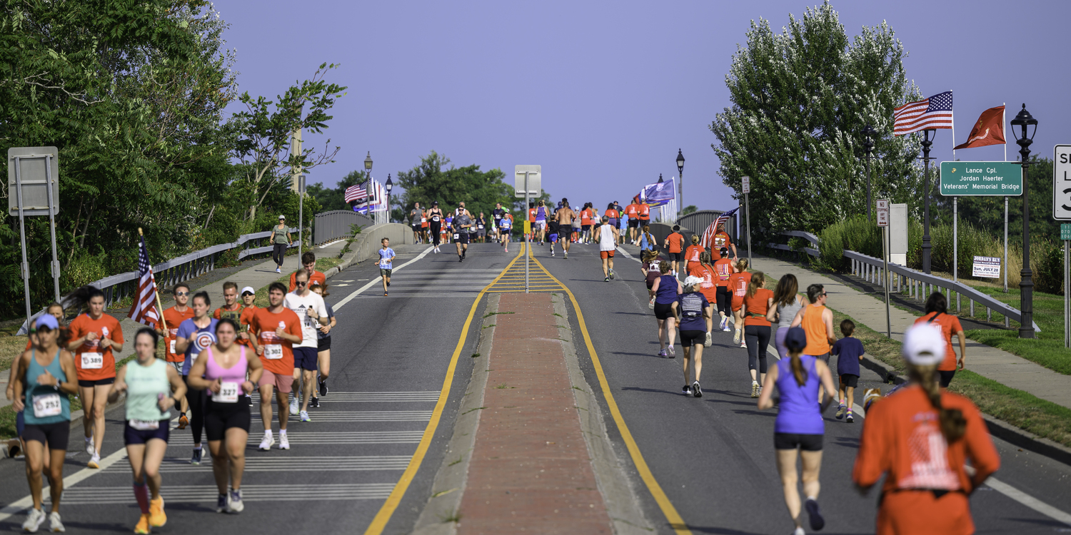 Runners and walkers line the Lance Cpl. Jordan Haerter Veterans' Memorial Bridge on Sunday morning during Jordan's Run.   MARIANNE BARNETT