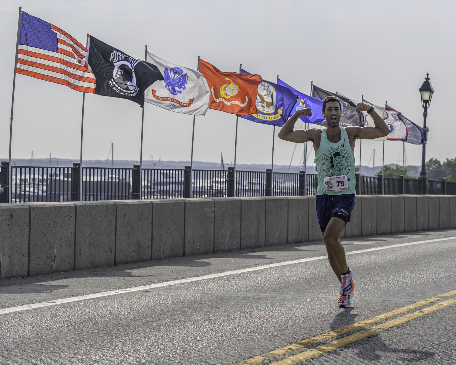 Benjamin Fleischman flexes as he crosses the Lance Cpl. Jordan Haerter Veterans' Memorial Bridge.   MARIANNE BARNETT