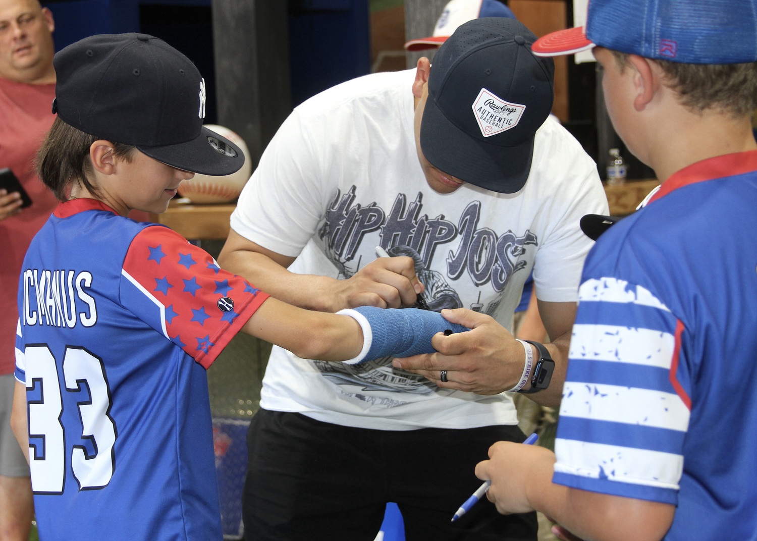 New York Yankees catcher Jose Trevino signs Logan McManus's cast. DESIRÉE KEEGAN