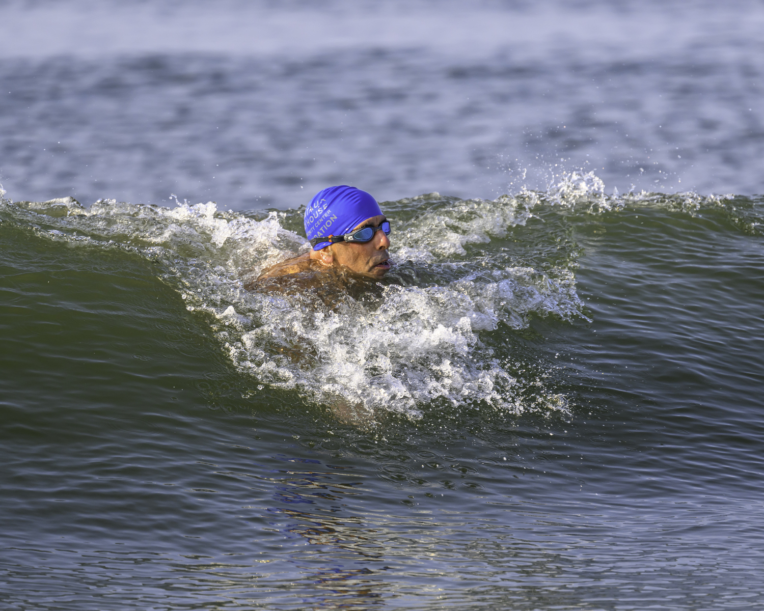 A 2-mile swimmer rides a wave in toward the finish.  MARIANNE BARNETT