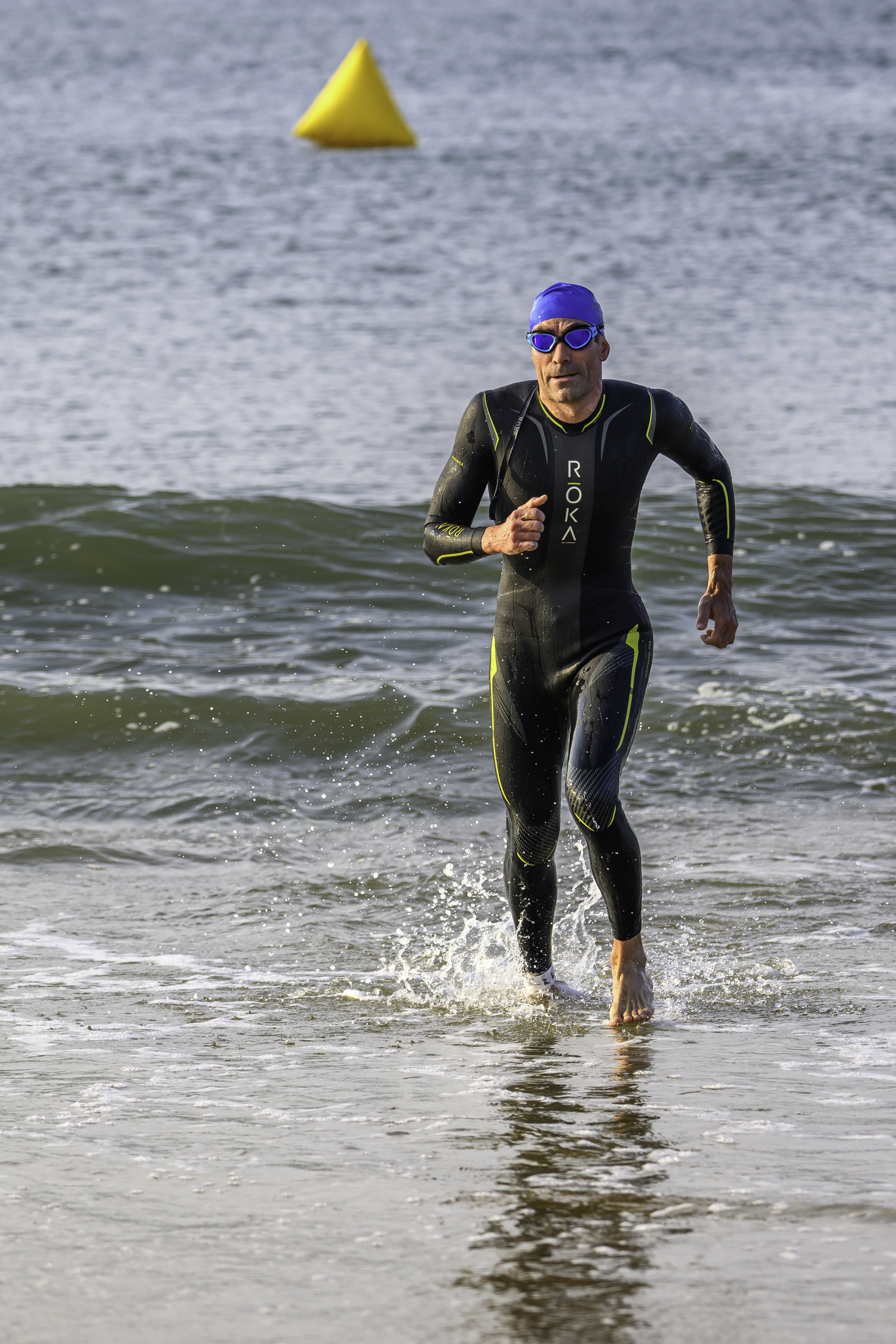 The overall winner of the 2-mile swim, Michal Petrzela, comes out of the water.   MARIANNE BARNETT