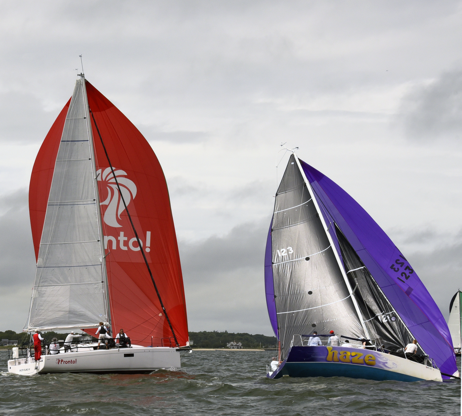 Pronto!, left, working her way up to leeward of Purple Haze, with foredeck crew furling the headsail after launching her chute.   MICHAEL MELLA