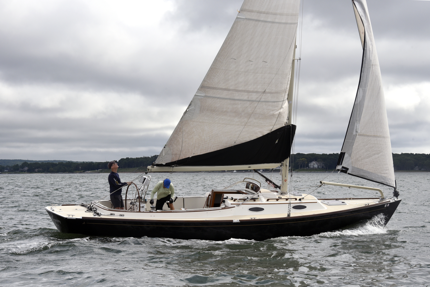 Alerion 33 skipper Jim Merrell, who also races a Rocket dinghy year-round on Sundays, at the wheel while Jim Vos tends to the mainsheet winch.  MICHAEL MELLA