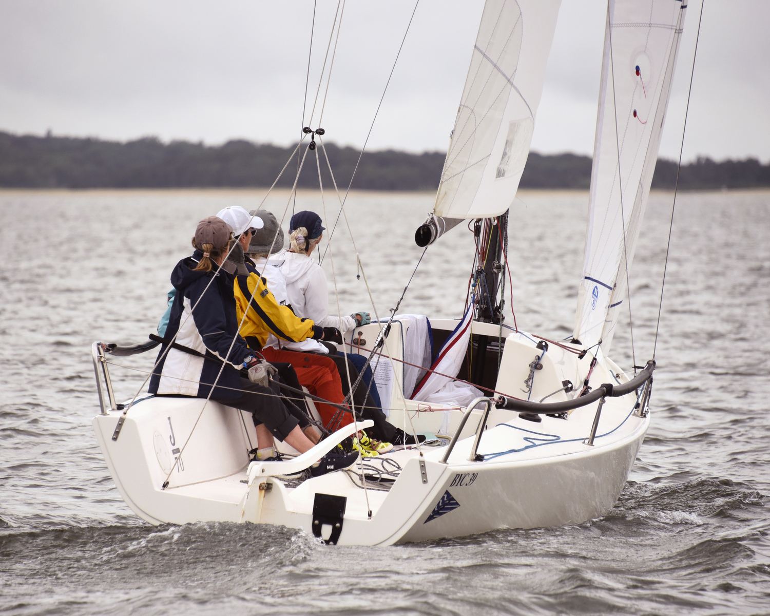 Sarah Alford at the helm of this “All Women” BYC J-70; perfectly trimmed close-hauled as they head for the weather mark.  MICHAEL MELLA