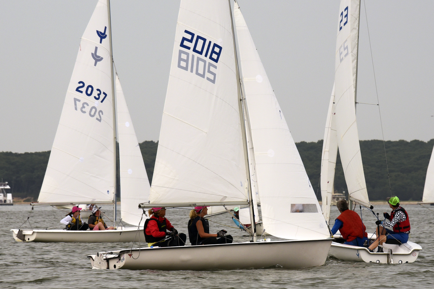 Second place Charlotte LeClue (sail #2037), slips to windward of first place Sara Nightingale, (sail #2018) as they decide how to navigate around Sinéad FitzGibbon’s boat, far right. MICHAEL MELLA