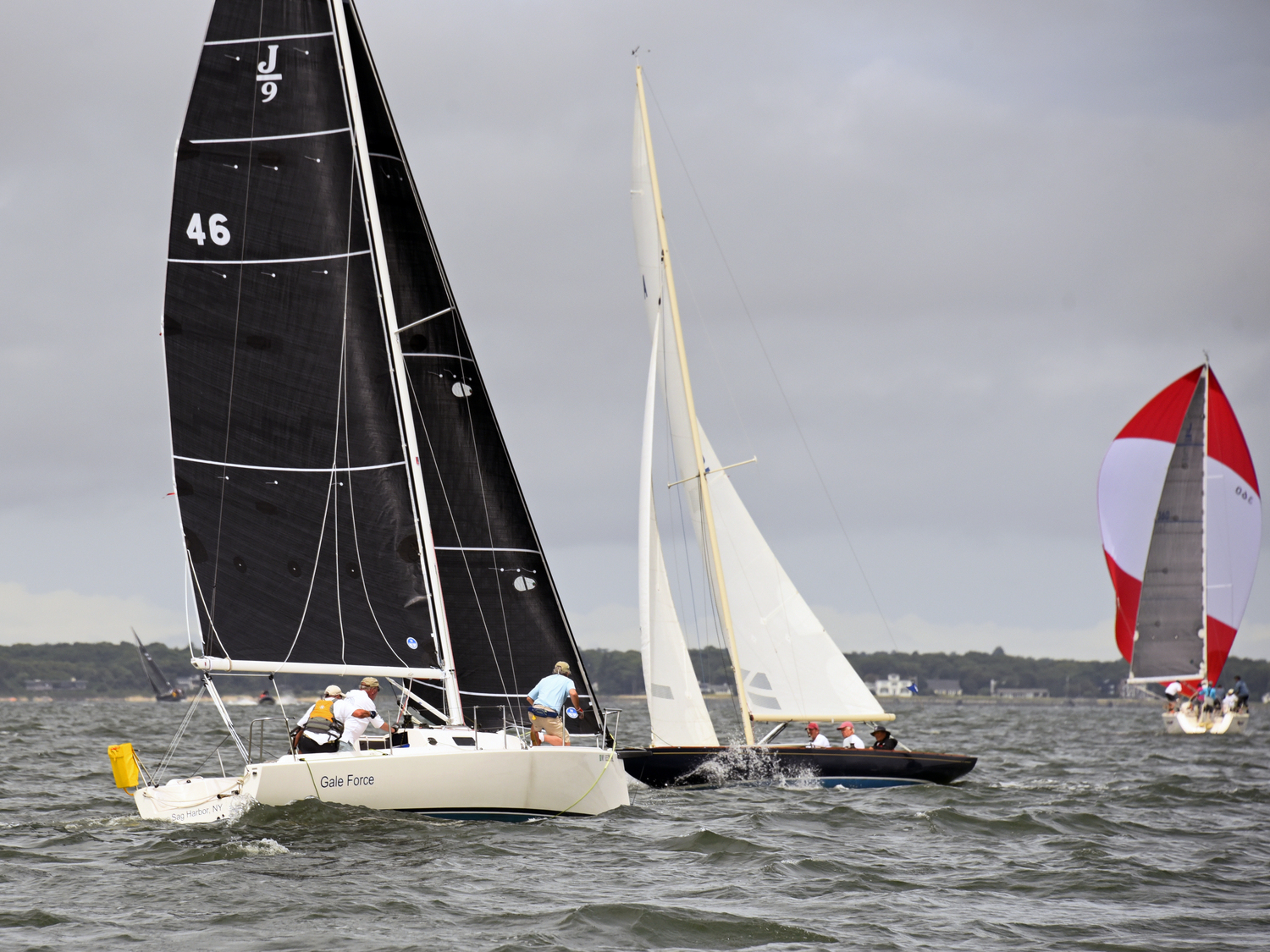 Gale Force skipper Richard Bockman, left, takes his turn on the foredeck, keeping a watchful eye on port-tack Starlight, as Big Boat moves ahead under a brilliant red and white spinnaker.  MICHAEL MELLA