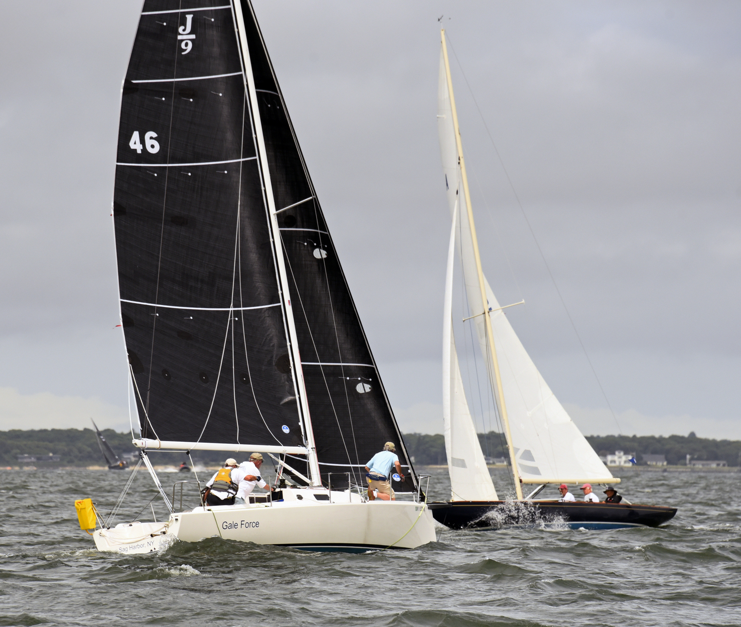 Gale Force skipper Richard Bockman, left, takes his turn on the foredeck, keeping a watchful eye on port-tack Starlight.   MICHAEL MELLA