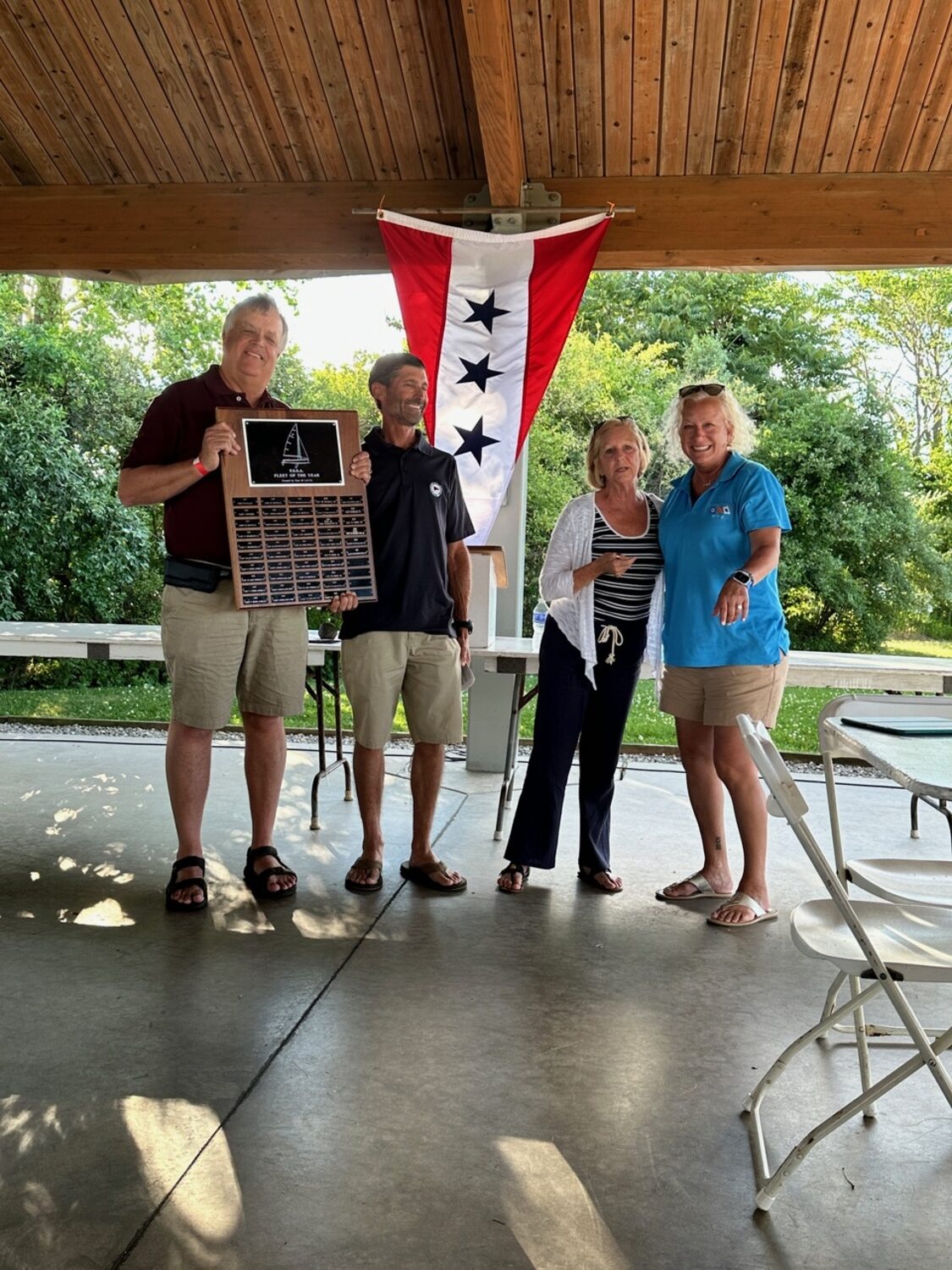 Flying Scot Sailing Association President Jim Leggette, left, presents the Fleet of the Year plaque to WYS Fleet Captain Dave Kisla, along with FSSA First Vice President Nina Cummings and Kirstin Naase.  COURTESY DAVE KISLA