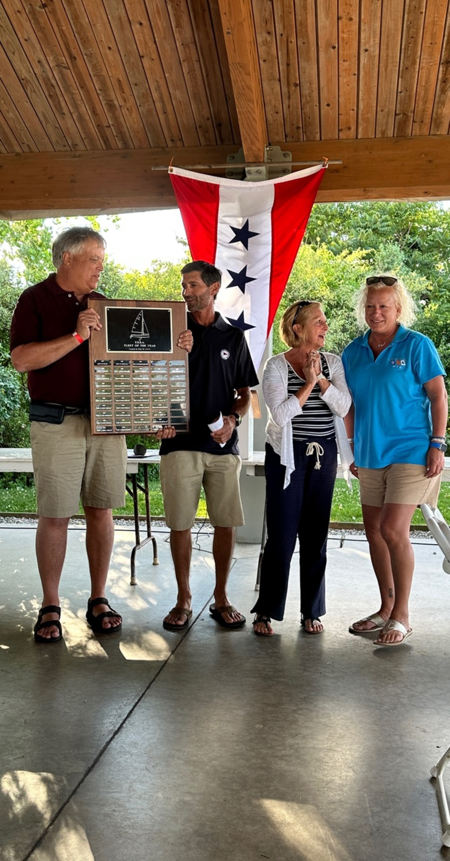 Flying Scot Sailing Association President Jim Leggette, left, presents the Fleet of the Year plaque to WYS Fleet Captain Dave Kisla, along with FSSA First Vice President Nina Cummings and Kirstin Naase.  COURTESY DAVE KISLA