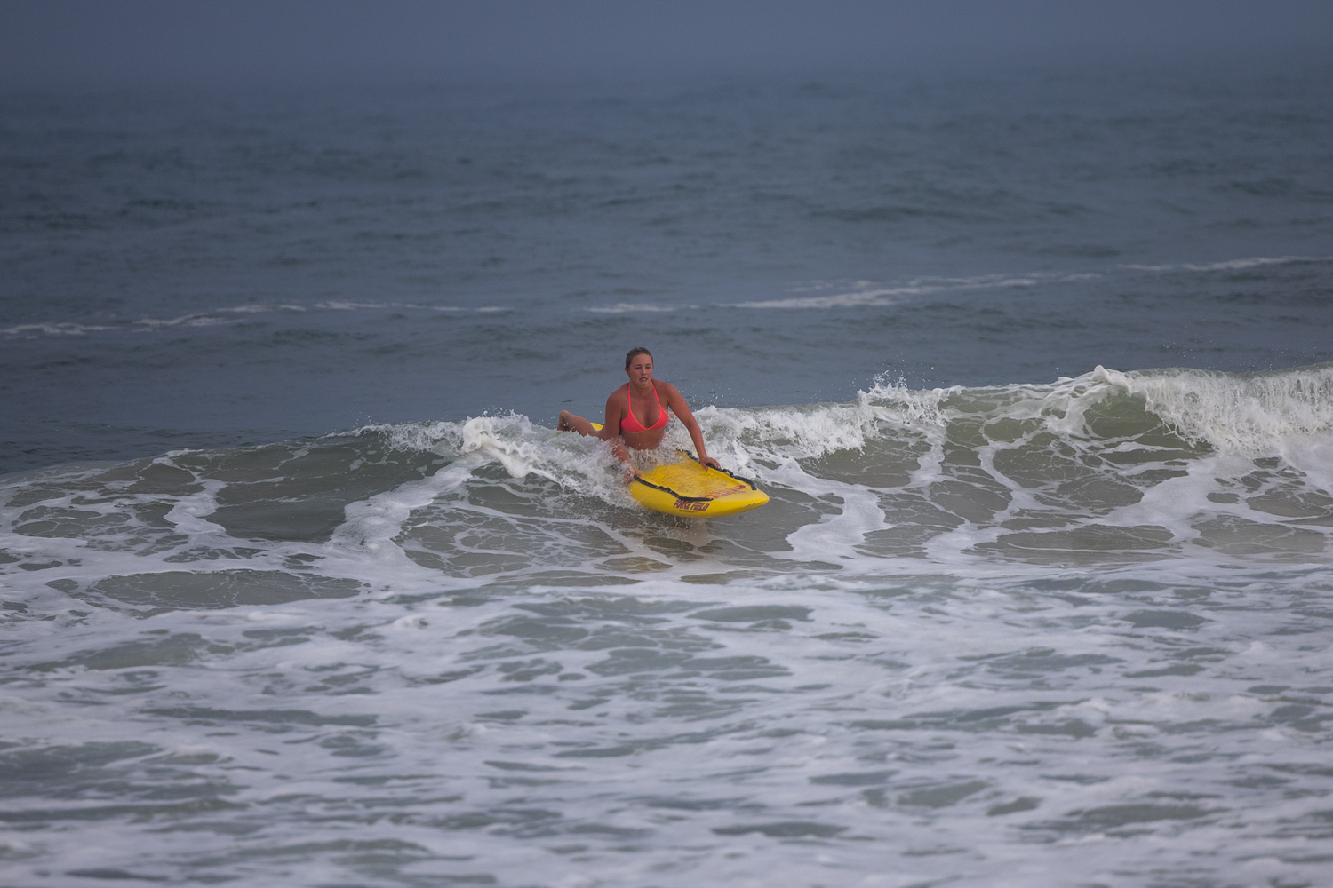 A lifeguard rides a wave in during the paddle board relay.   RON ESPOSITO