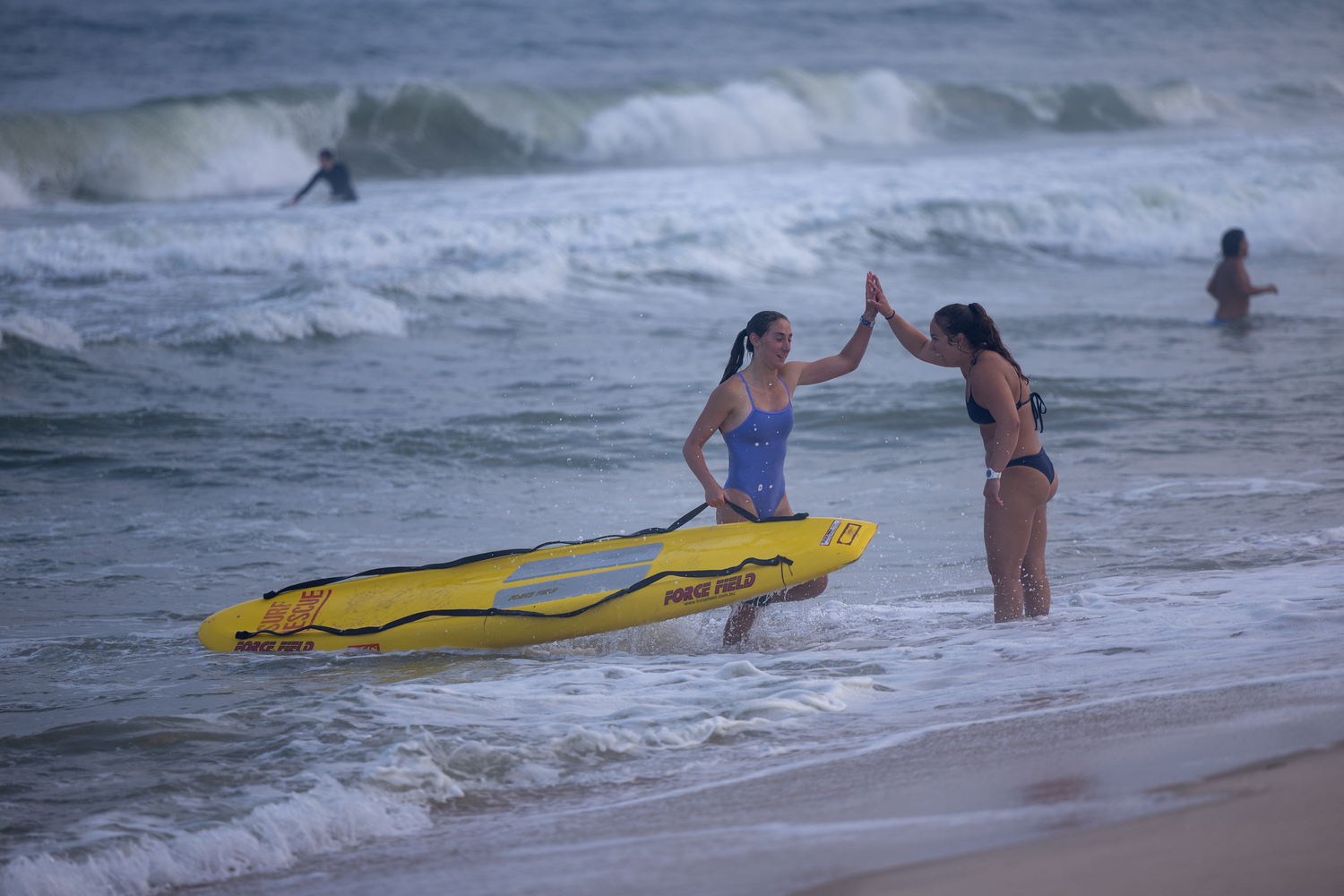 A lifeguard comes out of the water in the paddle board relay.   RON ESPOSITO