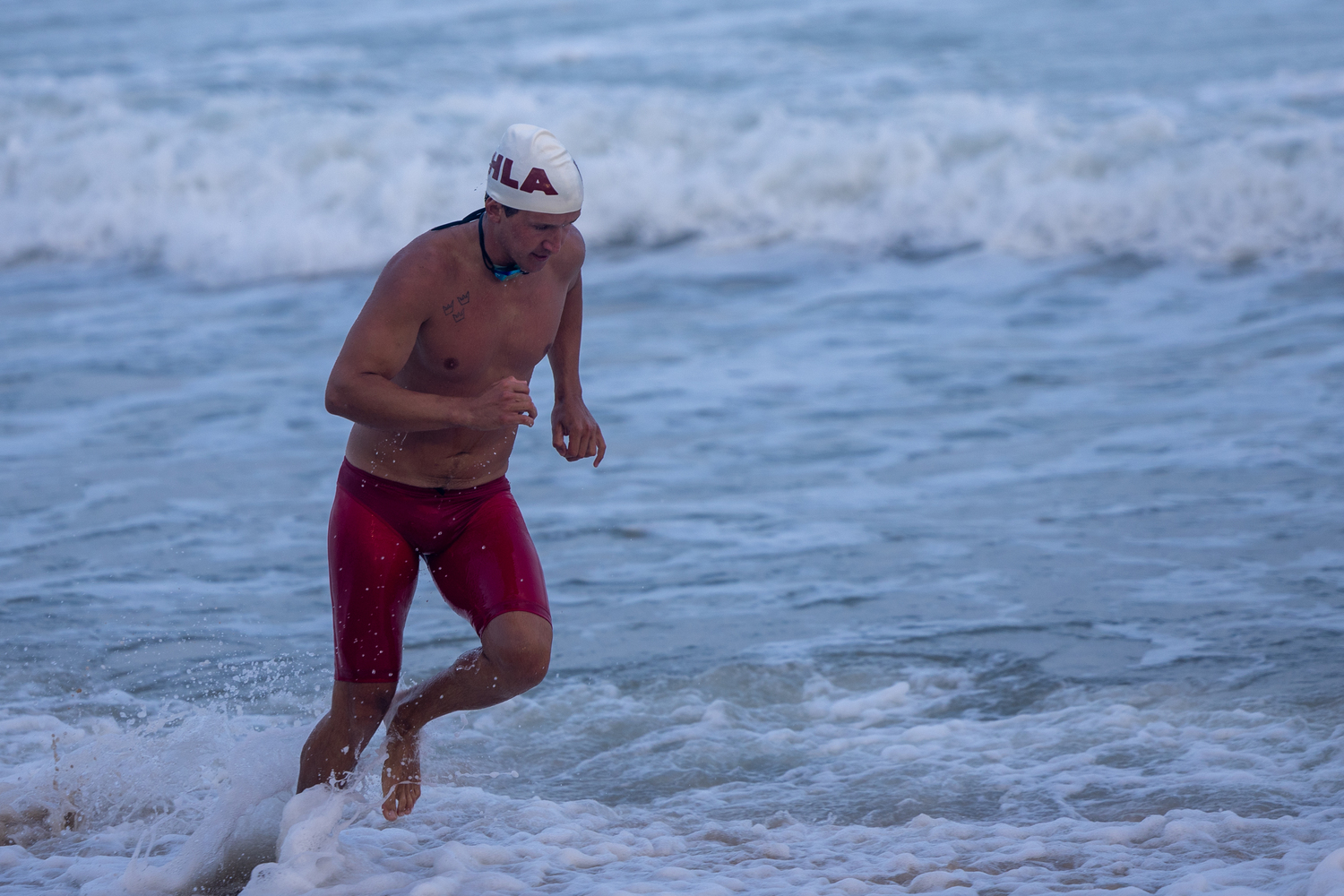 A guard heads out of the water in the run-swim-run.   RON ESPOSITO