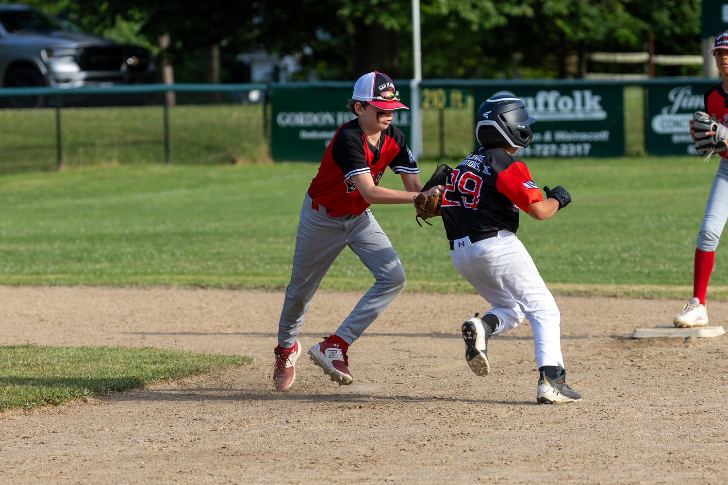 Cade Fischer tags out a North Patchogue-Medford base runner.   RON ESPOSITO