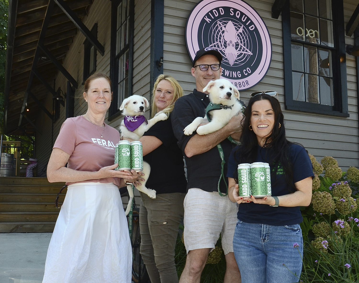 Animal Rescue Fund of the Hamptons Executive Director Kim Nichols, Kidd Squid owners, Grainne Coen and Rory McEvoy and Tess Pintchik, with Ashton and Alyssa at the ARF Hamptons 50 Pilsner release party and adoption event on Saturday at Kidd Squid Brewing Co. in Sag Harbor.  KYRIL BROMLEY