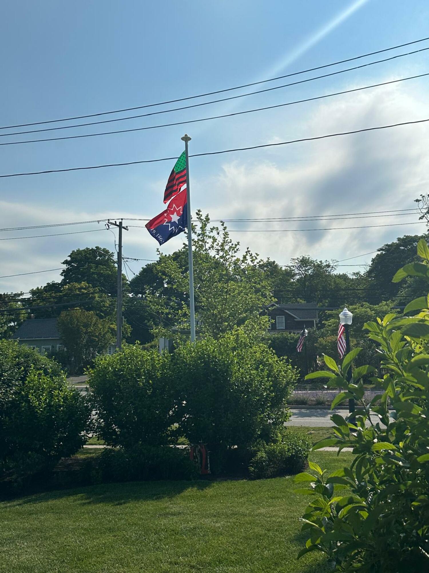 The red, black and green Pan-African flag, also known as the Marcus Garvey flag, and the red, white and blue Juneteenth flag, are now flying at the Southampton African American Museum. COURTESY SAAM