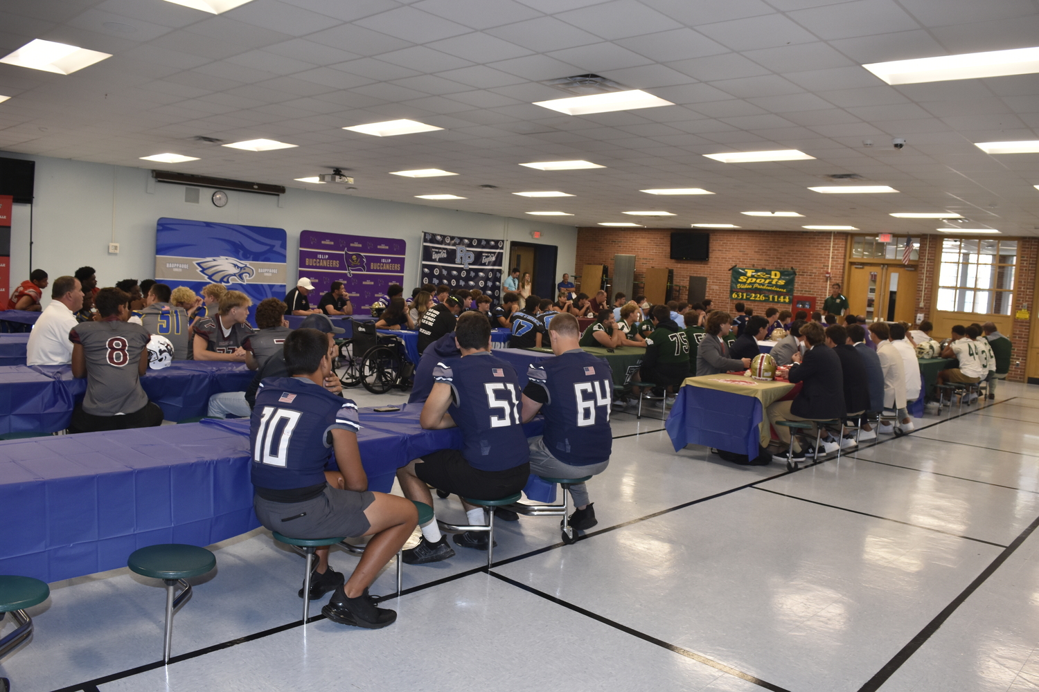 A packed cafeteria for the Suffolk County Division III portion of the media day at Ward Melville High School on Friday.   DREW BUDD