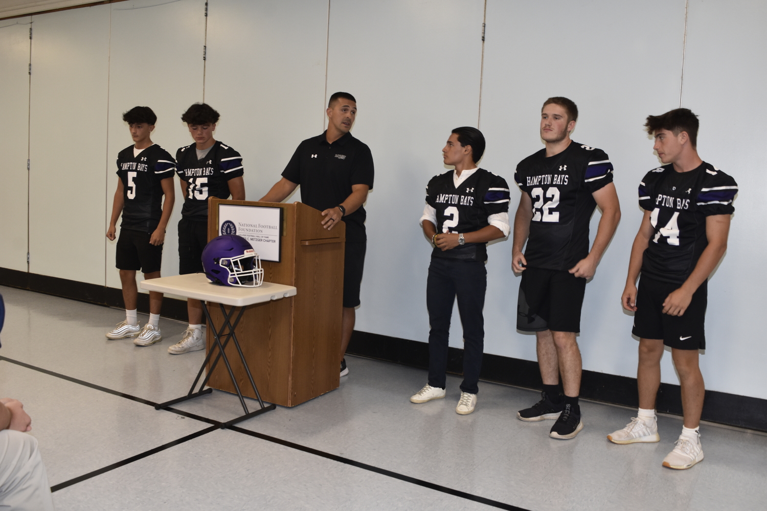 Hampton Bays head coach Sean Gil talks about his football program at the inaugural Suffolk County Football Media Day at Ward Melville High School on Friday.   DREW BUDD