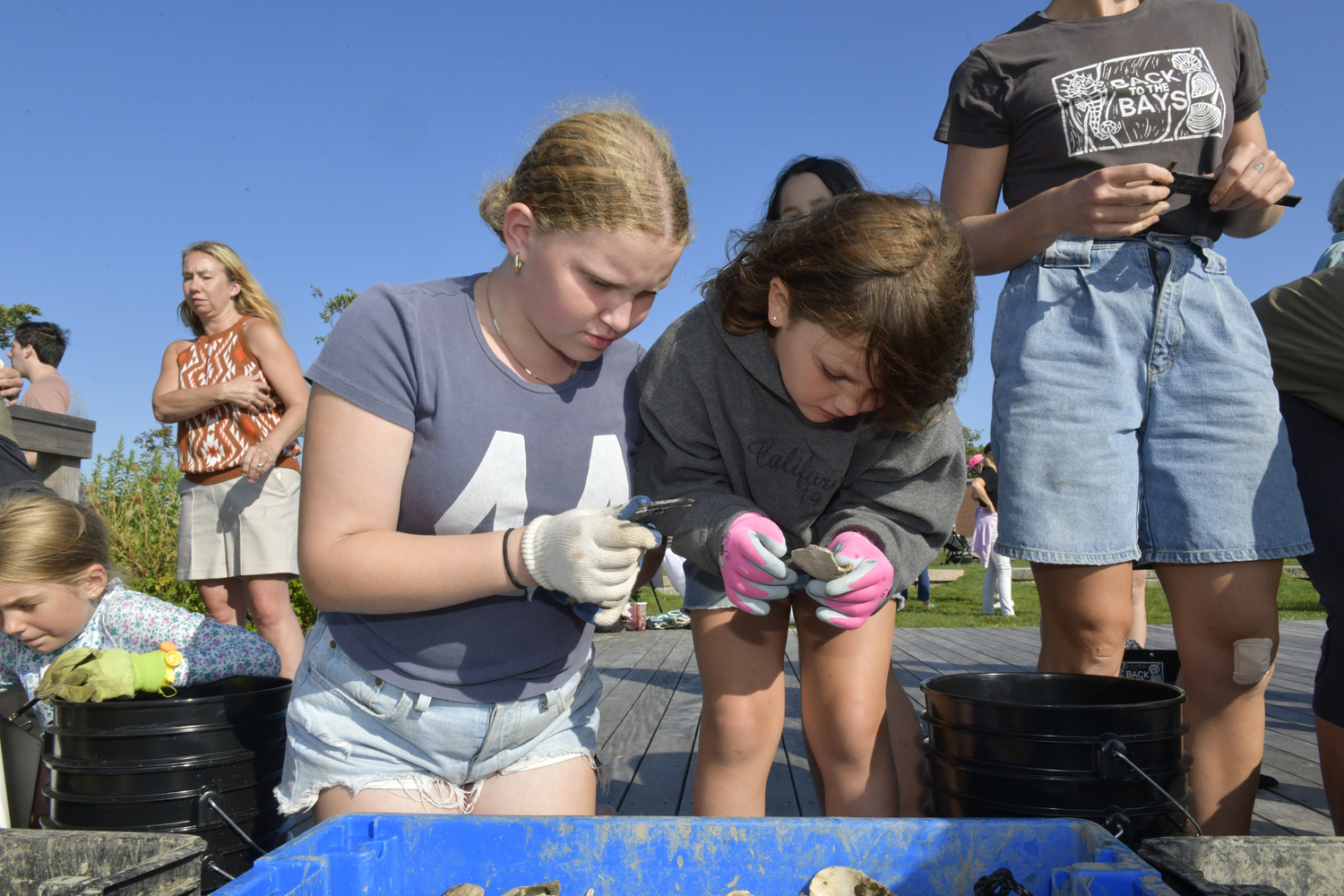 Tatum Fromson and Ella Sachs collect data at the 