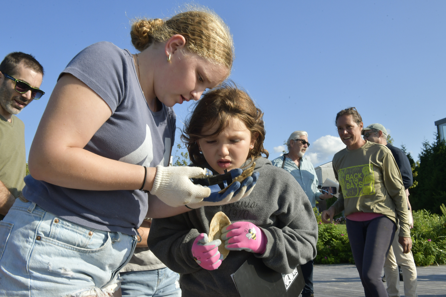 Tatum Fromson and Ella Sachs collect data at the 