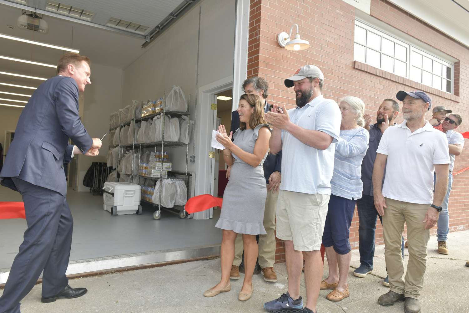 Mayor Bill Manger cuts the ribbon oat the new headquarter of Heart of the Hamptons on Meeting House Lane on July 31.  DANA SHAW