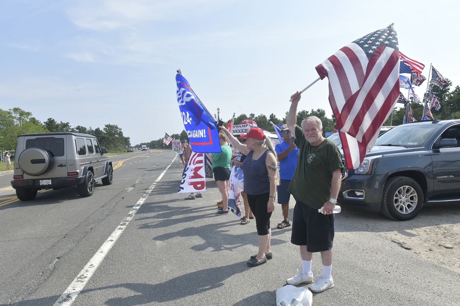 Supporters of former President Donald Trump lined a portion of Old Riverhead Road near Gabreski Airport in Westhampton Beach, waiting for hours to catch a glimpse of the passing motorcade. The former President's visit to the Bridgehampton home of Cantor Fitzgerald CEO Howard Lutnick for a campaign fundraiser. The visit brought traffic to a standstill across the east end for hours on Friday evening.  DANA SHAW