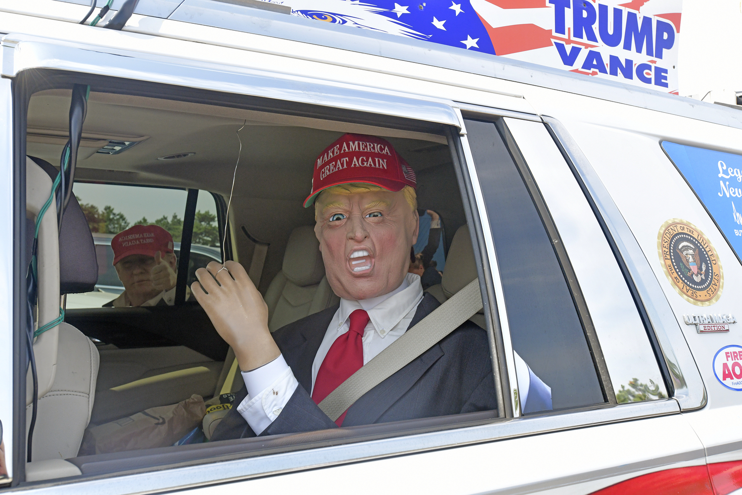 Supporters of former President Donald Trump lined a portion of Old Riverhead Road near Gabreski Airport in Westhampton Beach, waiting for hours to catch a glimpse of the passing motorcade. The former President's visit to the Bridgehampton home of Cantor Fitzgerald CEO Howard Lutnick for a campaign fundraiser. The visit brought traffic to a standstill across the east end for hours on Friday evening.  DANA SHAW