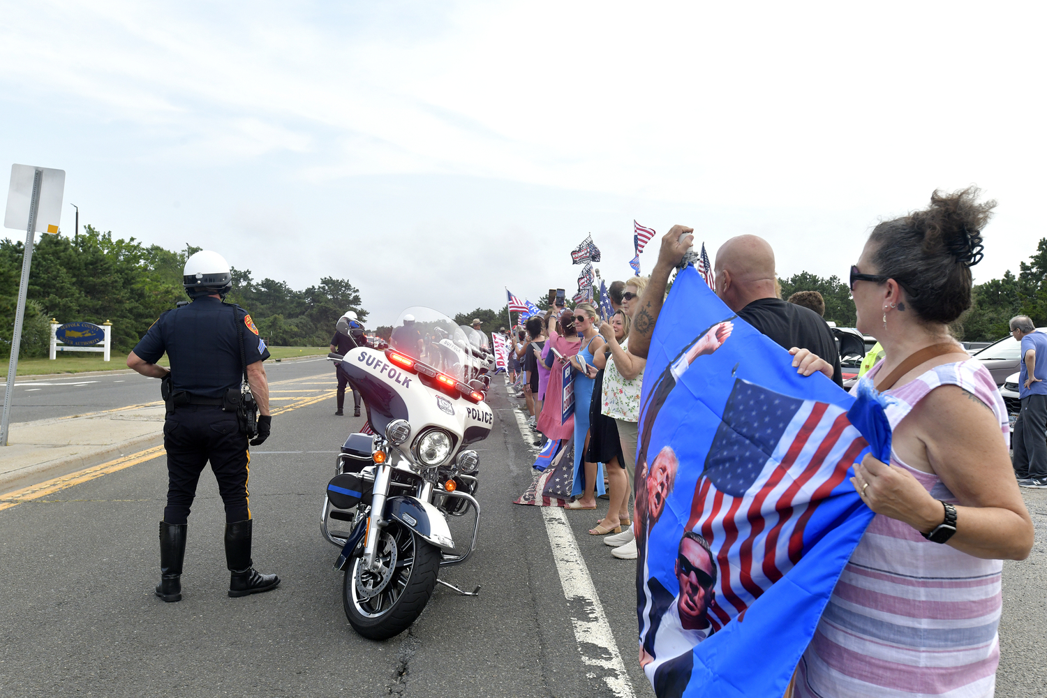 Supporters of former President Donald Trump lined a portion of Old Riverhead Road near Gabreski Airport in Westhampton Beach, waiting for hours to catch a glimpse of the passing motorcade. The former President's visit to the Bridgehampton home of Cantor Fitzgerald CEO Howard Lutnick for a campaign fundraiser. The visit brought traffic to a standstill across the east end for hours on Friday evening.  DANA SHAW