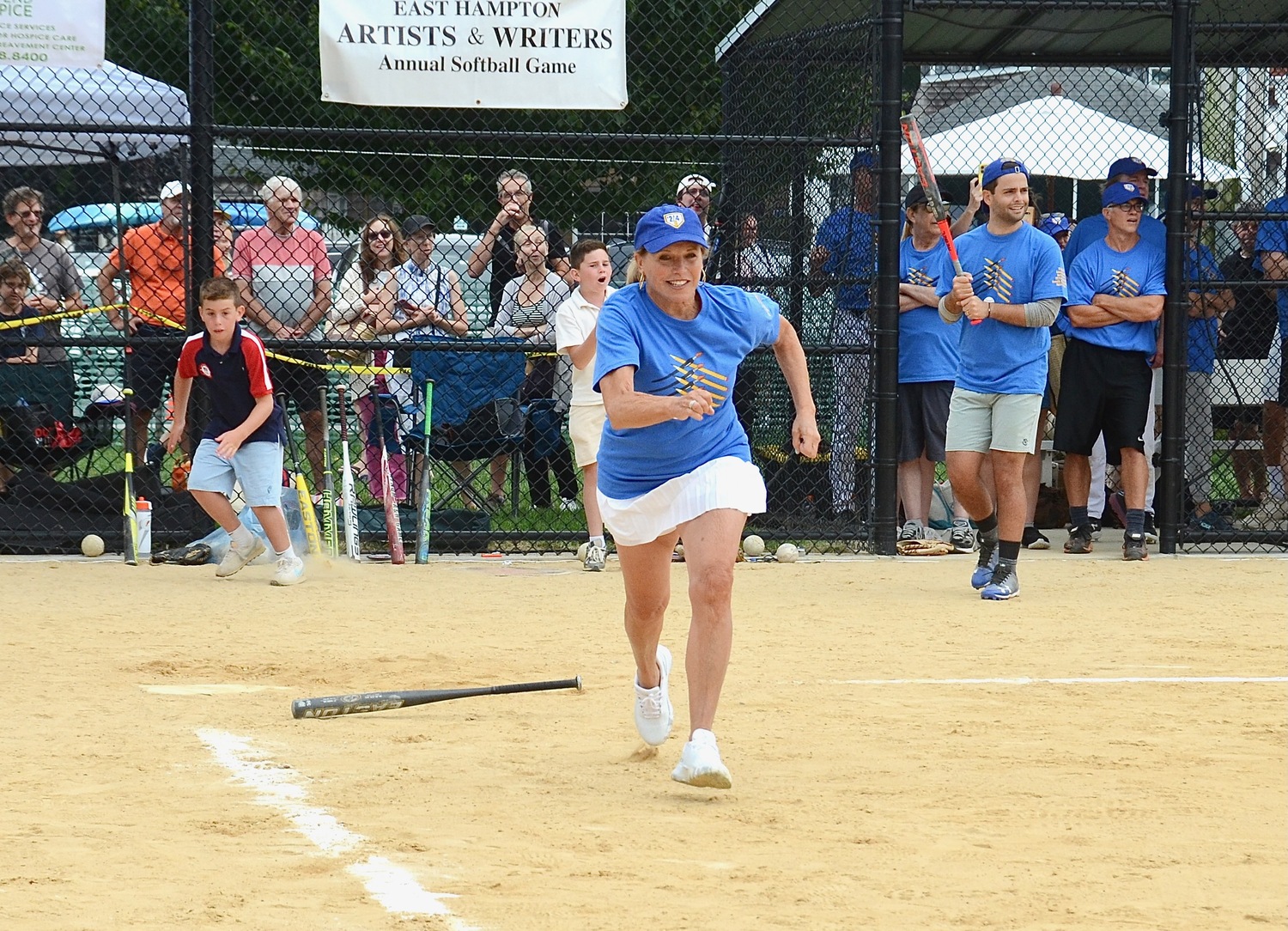 Katie Couric heads to first after putting the ball in play.   KYRIL BROMLEY