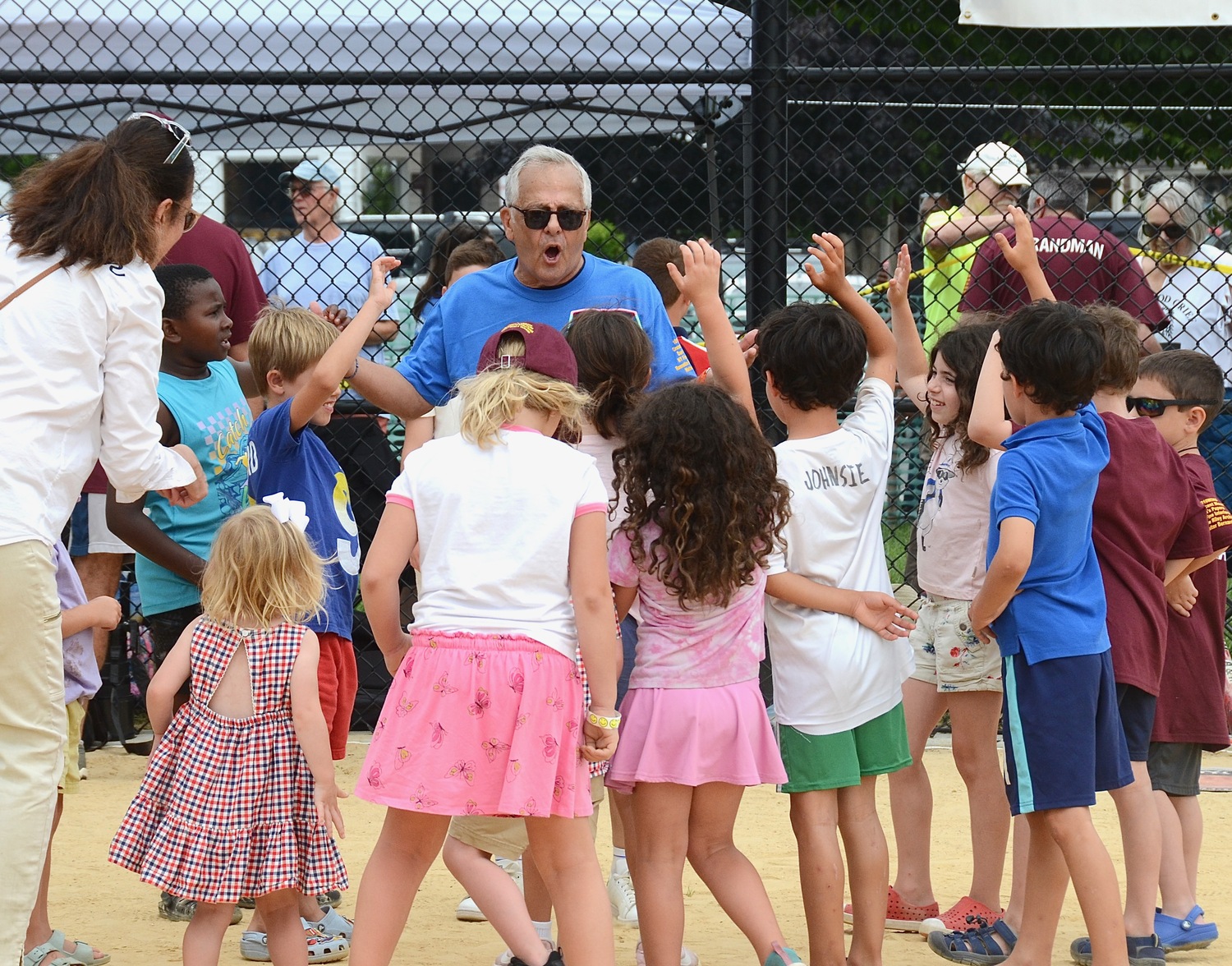 Mike Lupica gathers kids for the spin-the-bat run around the bases in the middle of Saturday's game.   KYRIL BROMLEY