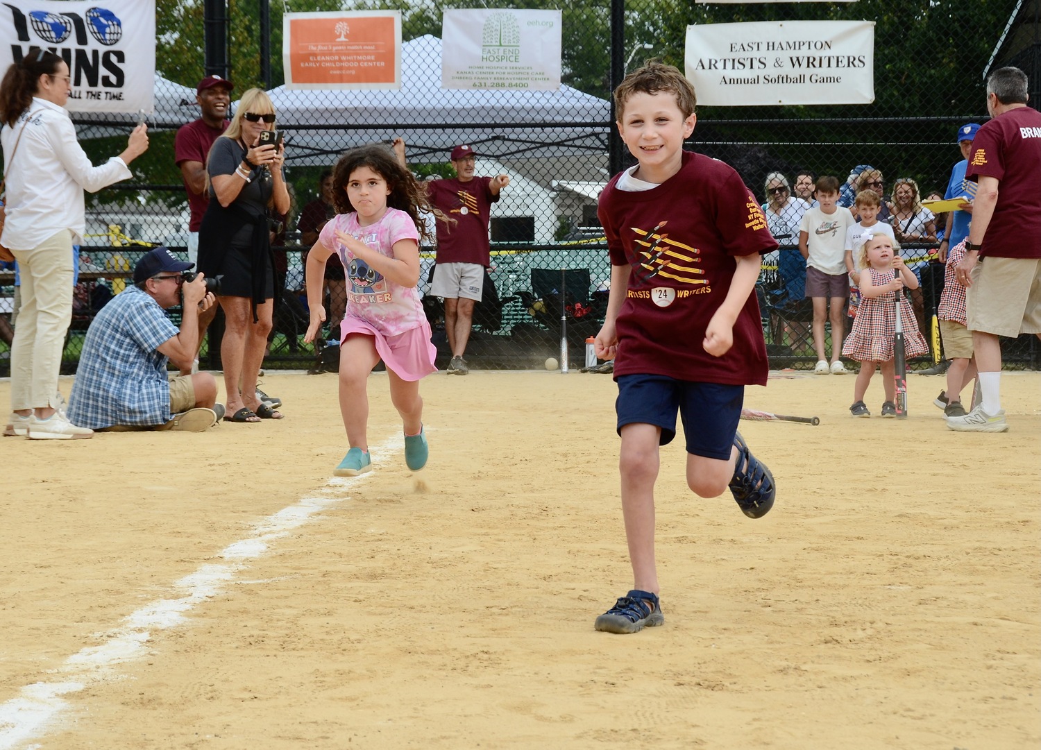 After spinning around a bat at home plate, kids run the bases.   KYRIL BROMELY