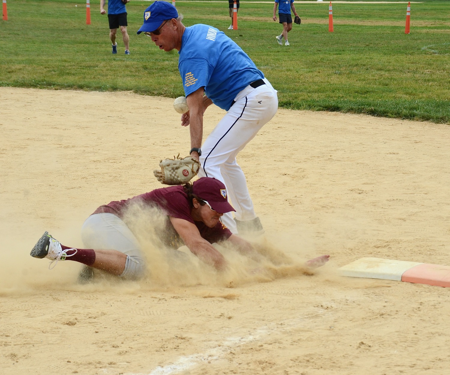 An Artist gets back to first safely as the ball alludes Paul Winum.   KYRIL BROMLEY