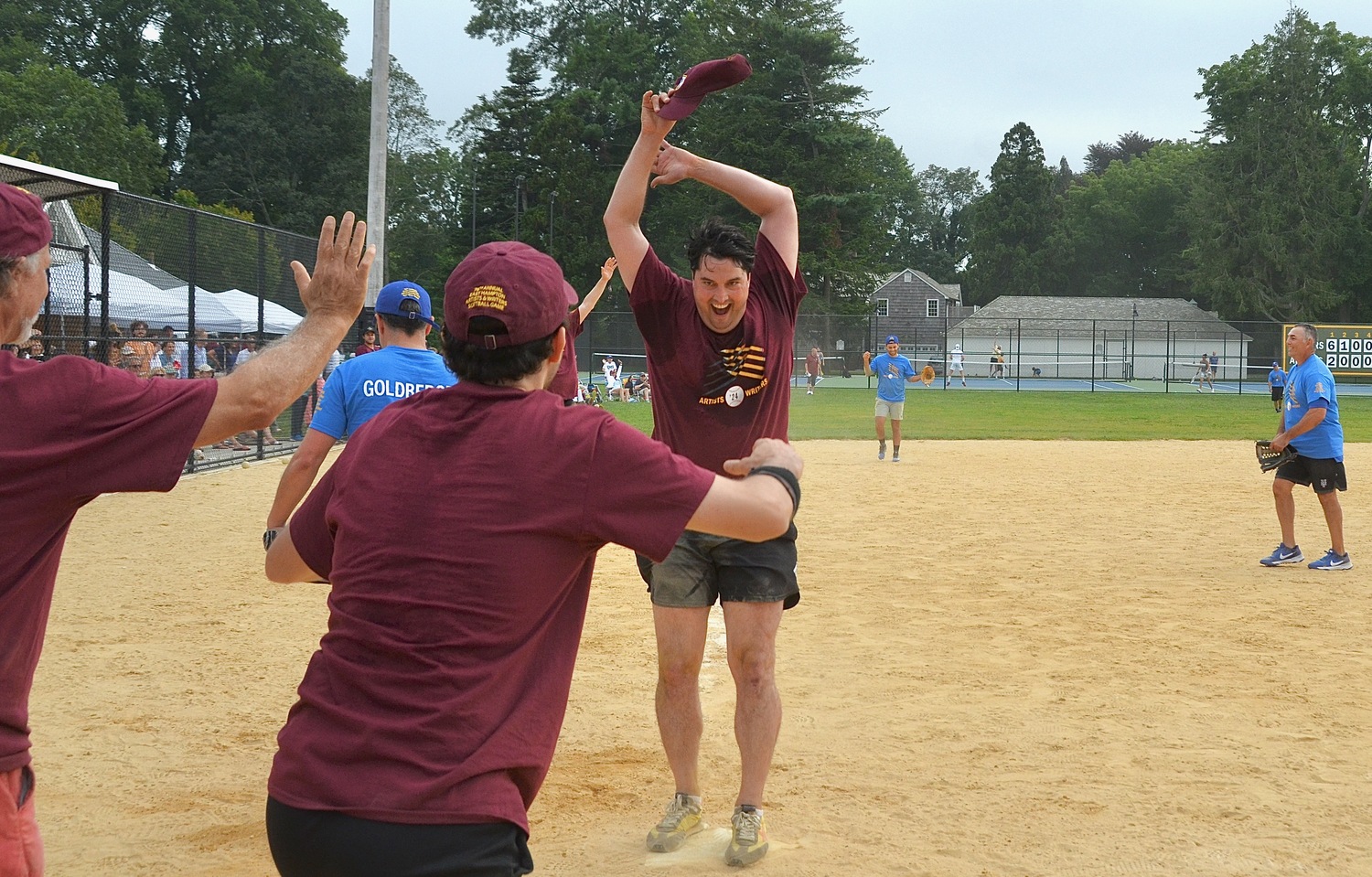 Parker Calvert scores the winning run for the Artists in the bottom of the 12th inning, giving them the 11-10 edge.  KYRIL BROMLEY