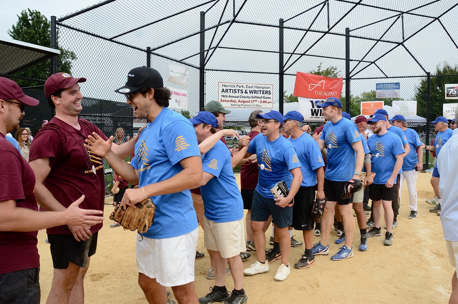 The Writers and Artists shake hands after their 12-inning affair at Herrick Park on Saturday afternoon.   KYRIL BROMLEY