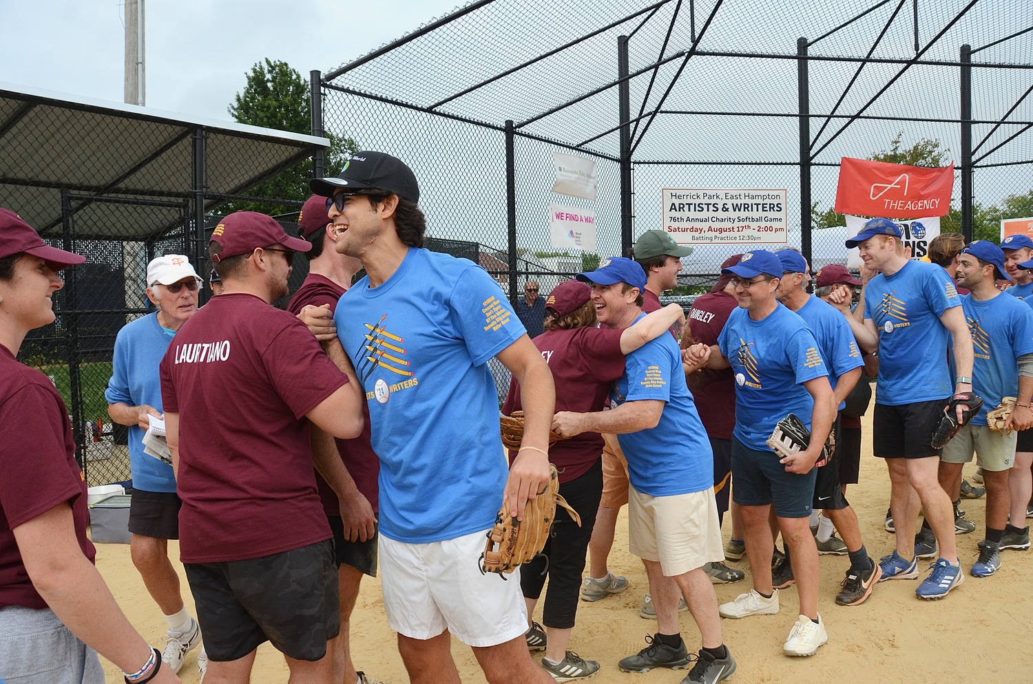 The Writers and Artists shake hands after their 12-inning affair at Herrick Park on Saturday afternoon.   KYRIL BROMLEY