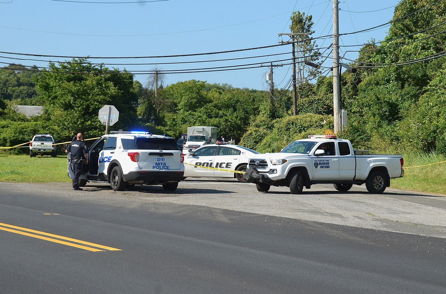 Police block the roadway earlier this afternoon during an incident on Edgemere Road in Montauk.     KYRIL BROMLEY