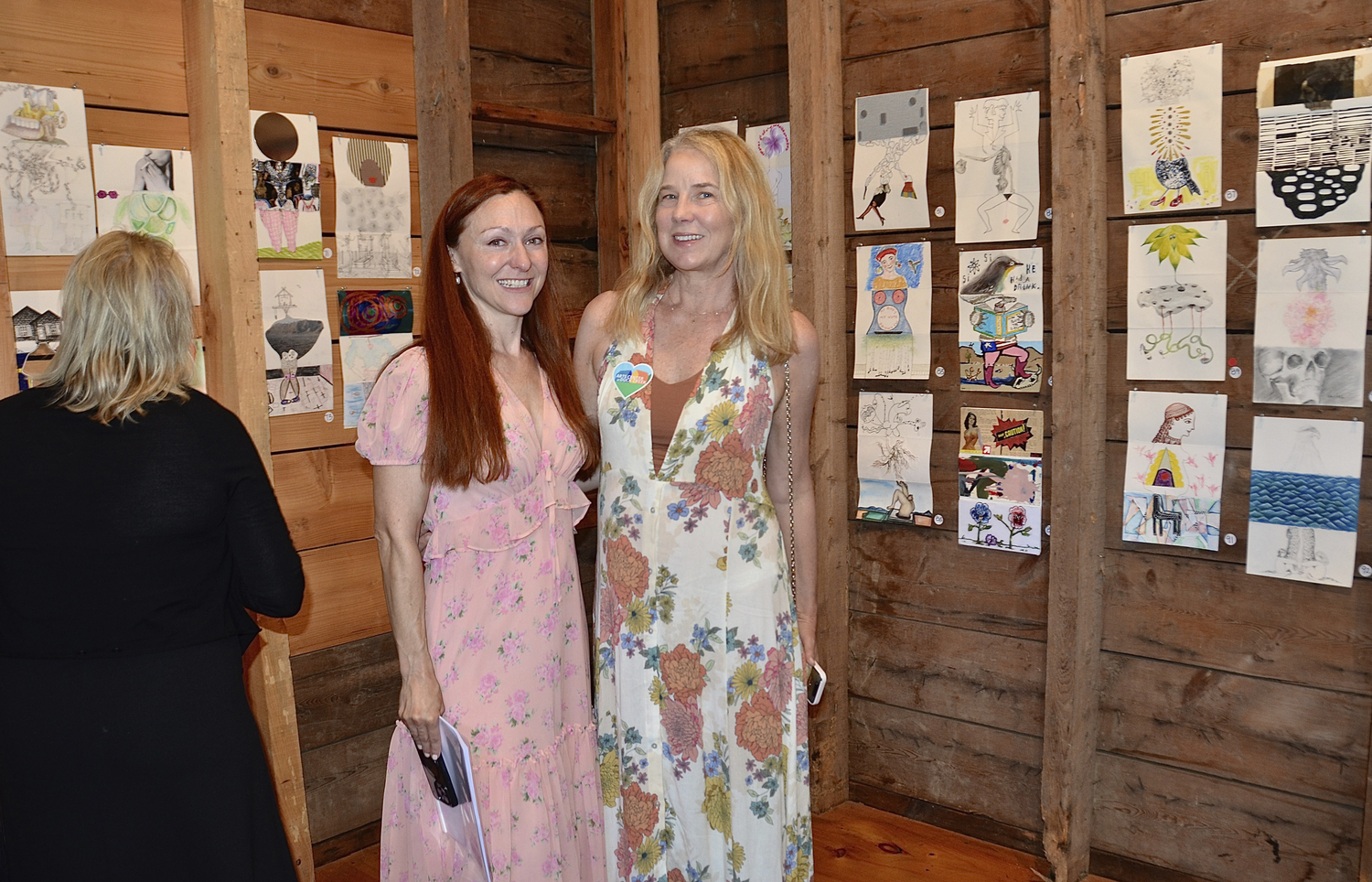 Elise Trucks and Stephanie Joyce at the Exquisite Corpse Drawathon Benefit preview party at the Arts Center at Duck Creek on Saturday.  KYRIL BROMLEY